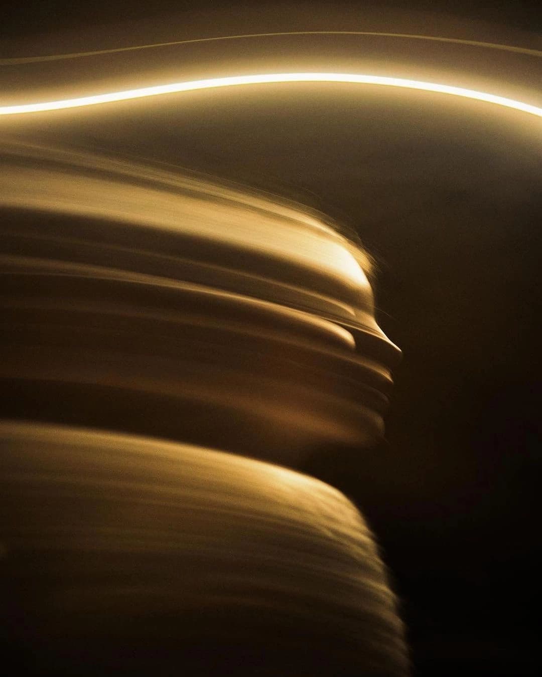 A line of warm light moving through the dark
